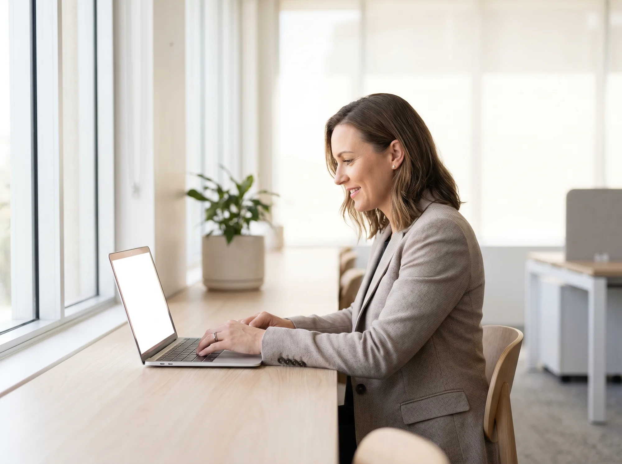 A solicitor working at a laptop in a bright modern office